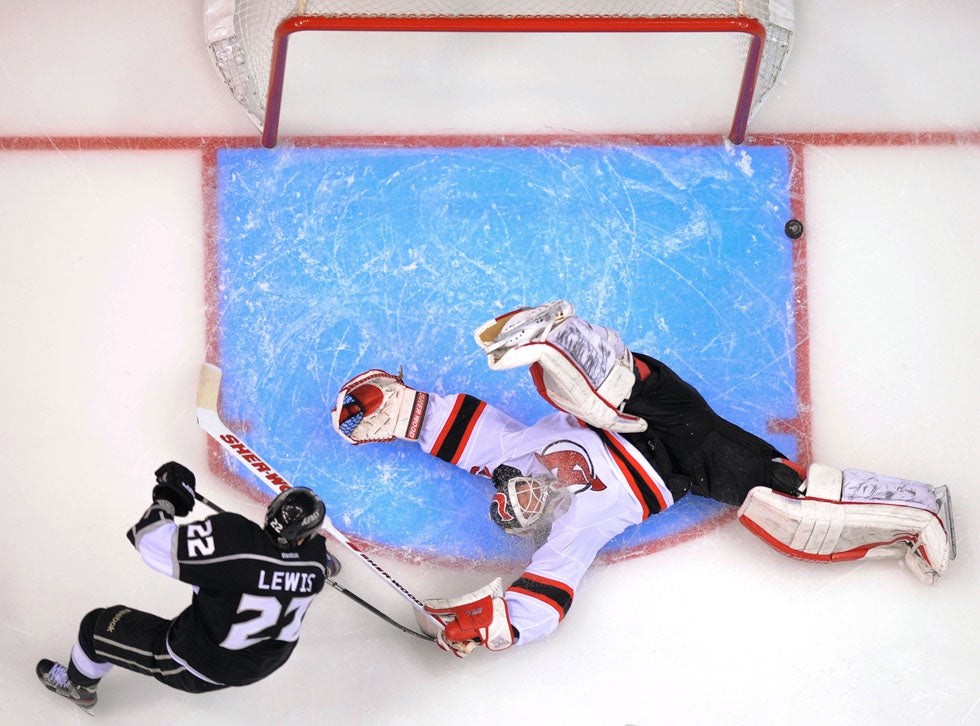 New Jersey Devils' goalie Martin Brodeur makes a save as the Los Angeles Kings' Trevor Lewis approaches in the third period during Game 4 of the NHL hockey Stanley Cup finals. The Devils would go on to win the game 3-1. Mark Terrill is an Associated Press staff photographer based in the Los Angeles area. He mainly shoots professional sporting events. Check out portfolios of his work on his <a href="http://www.sportsshooter.com/members.html?id=34">SportsShooter page</a>.