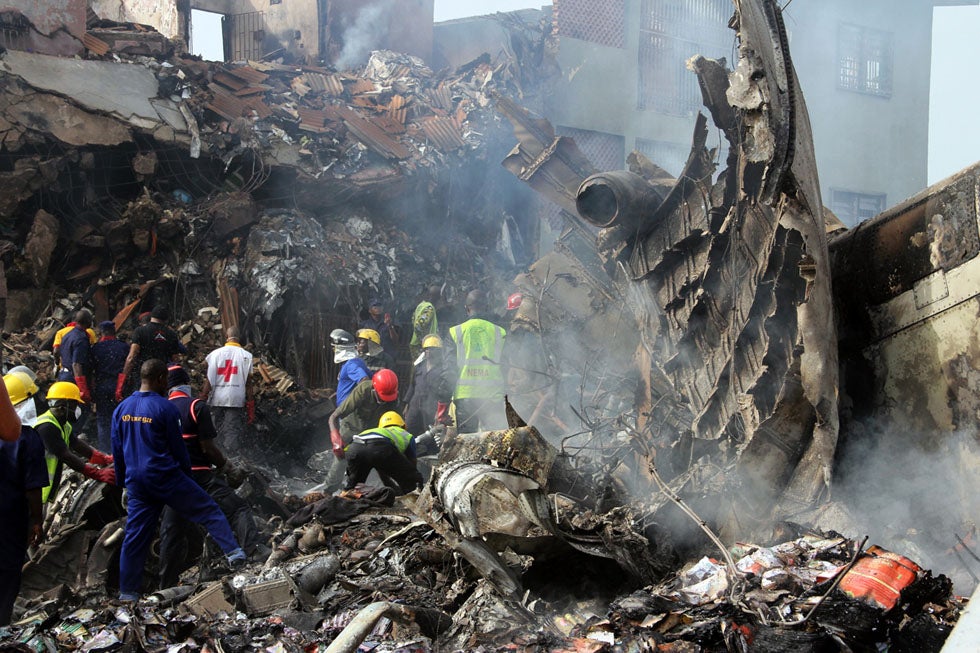 Rescuers and firefighters search for survivors at the sight of a devastating commercial airline crash in a densely populated area of Lagos, Nigeria. The crash killed all 153 aboard. Emmanuel Arewa is a stringer working for AFP in Nigeria.