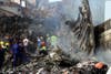 Rescuers and firefighters search for survivors at the sight of a devastating commercial airline crash in a densely populated area of Lagos, Nigeria. The crash killed all 153 aboard. Emmanuel Arewa is a stringer working for AFP in Nigeria.