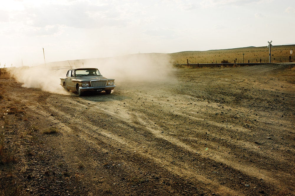 Newberry's shot of a vintage Valiant on a dusty road, from <em>Halfway to Midland.</em> "I come from a car culture," she says. "It's a huge symbol of what I consider the passing of time and this landscape that I happen to live in."