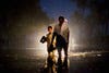 Mueen Ibrahim, 10, peers around the back of his grandfather Ghulam Qadir, 52, displaced by floods, walk through flood waters on August 22, 2010 in the village of Baseera near Muzaffargarh in Punjab, Pakistan. Ghulam, walked his one water buffalo and three goats to safety to higher ground, before evacuating his family and their belongings two days before the floods hit his home in Basti Jagwala.