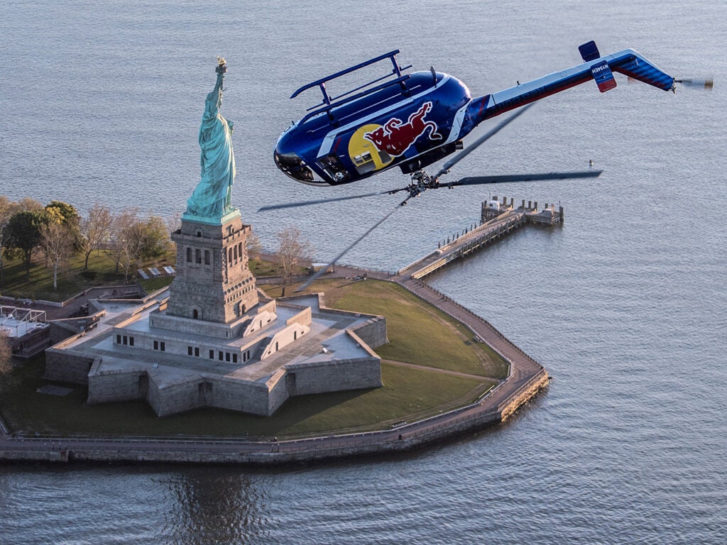 Redbull helicopter upside down over Statue of Liberty