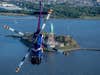 Redbull helicopter performing stunts with the Statue of Liberty in the background