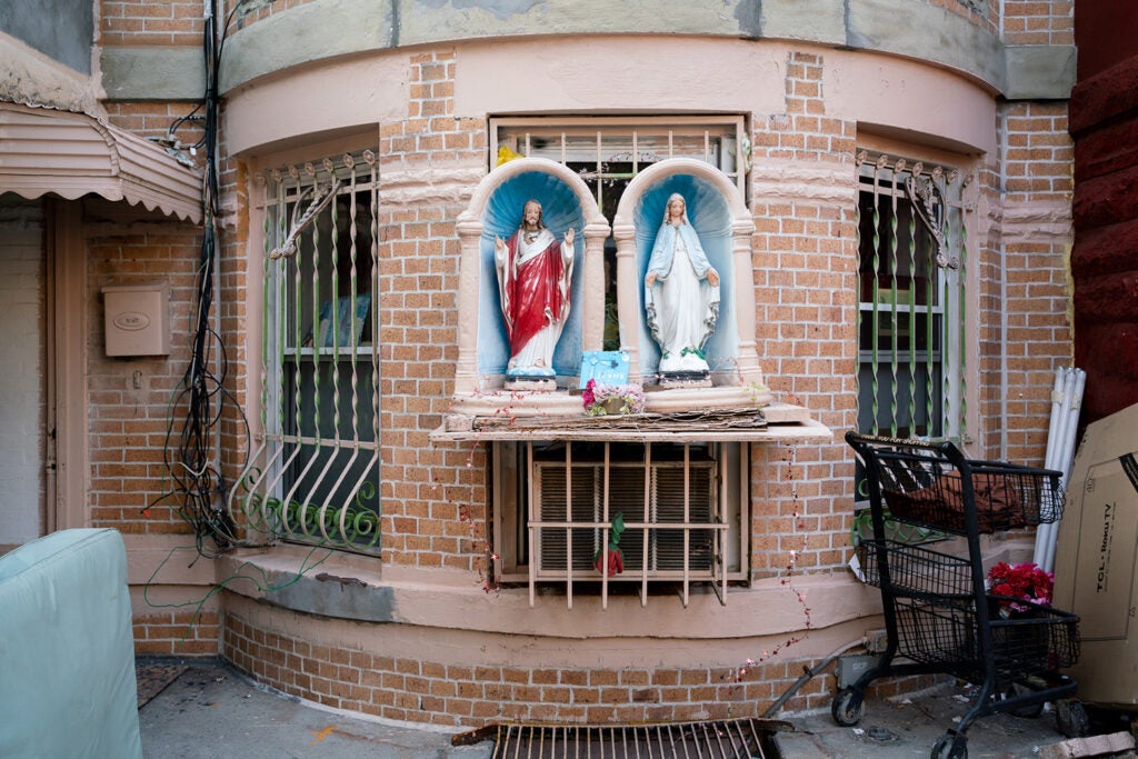 Religious figures outside of an apartment building