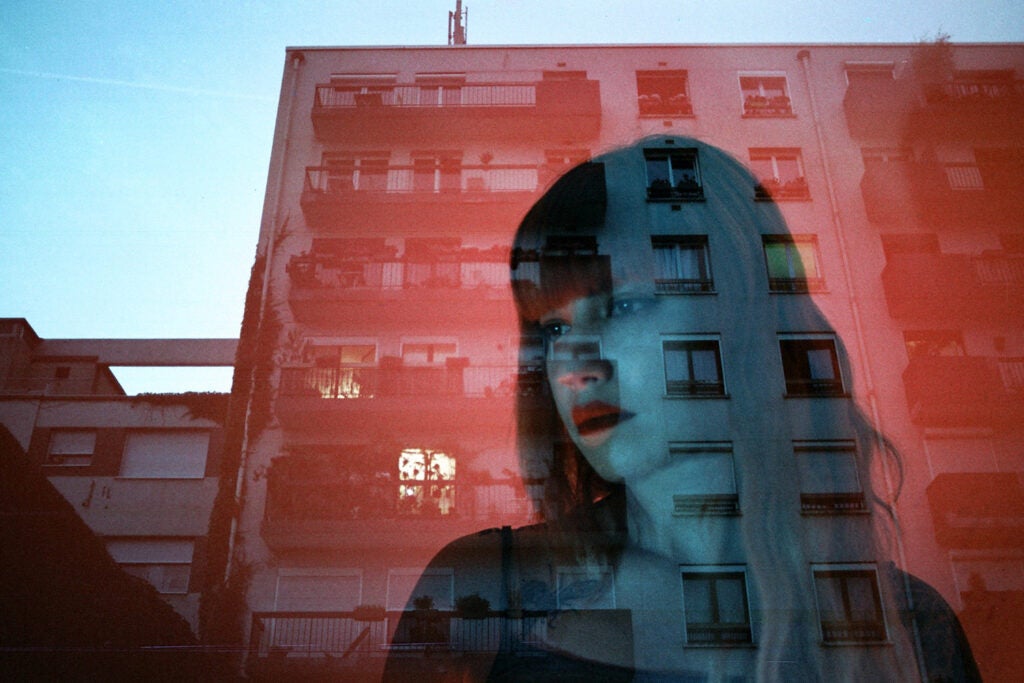 blue reflection of girl and red building