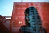 blue reflection of girl and red building