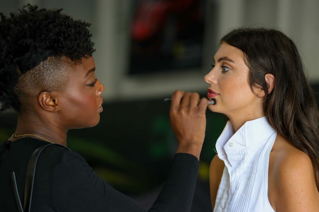 makeup being applied to womans face