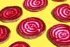 sliced beets on yellow background