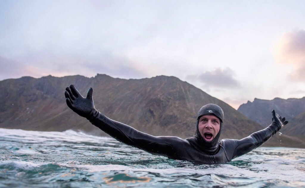 surfer Mick Fanning swimming in wetsuit