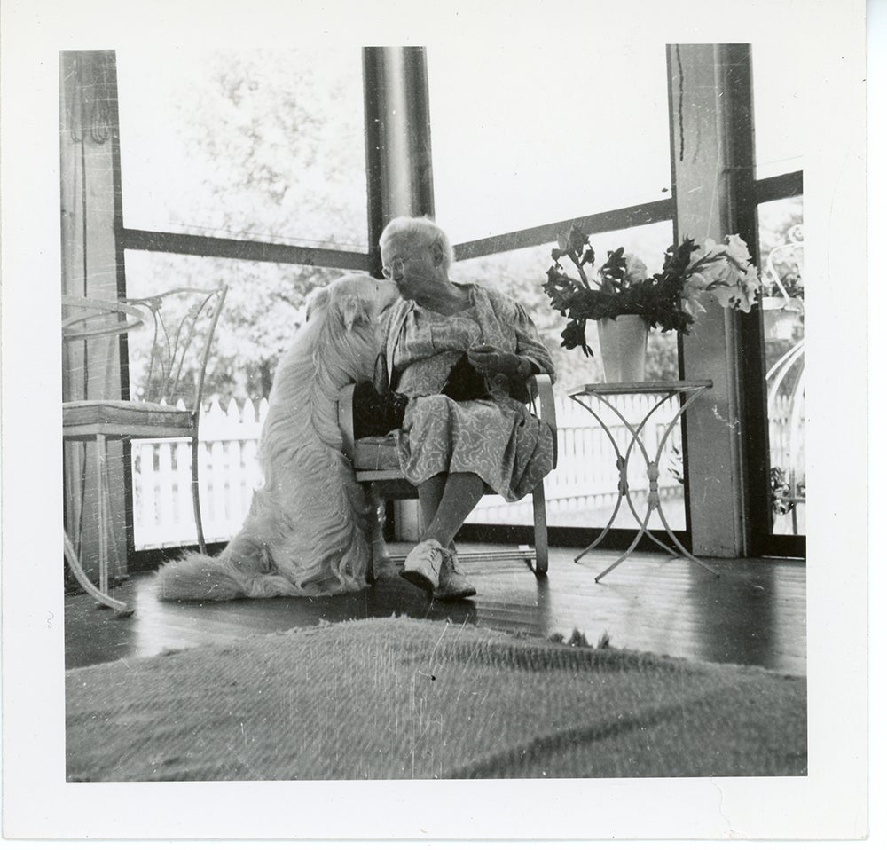 older woman giving her dog a kiss