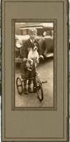 child and dog riding tricycle