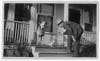 man and two dogs on the porch