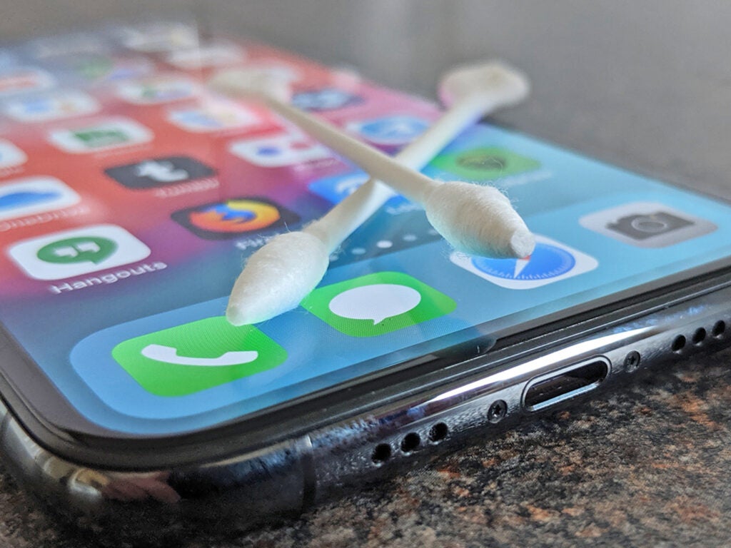 two cotton swabs laying on an iphone