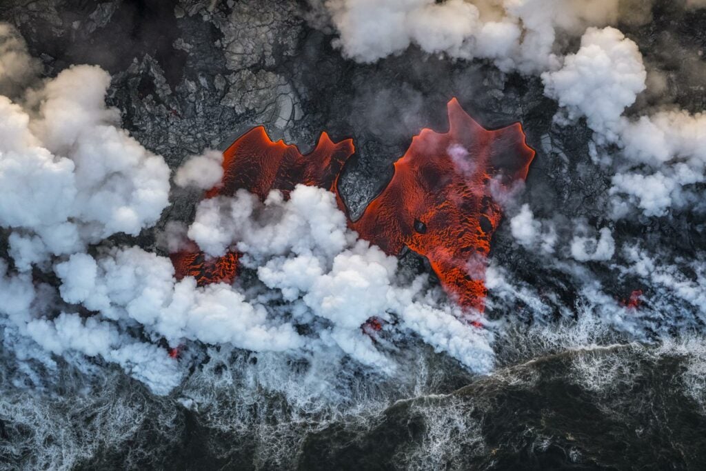 Aerial of lava flowing into the Pacific Ocean