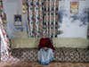 A widow sitting in the couch in Durga Kund Help Line ashram