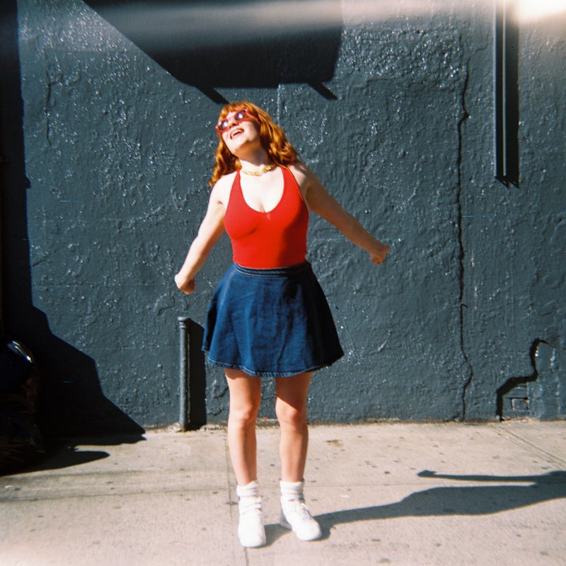 girl in blue skirt and red tank top