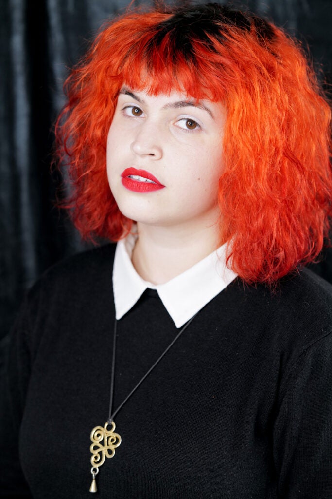 woman in black with fiery orange hair