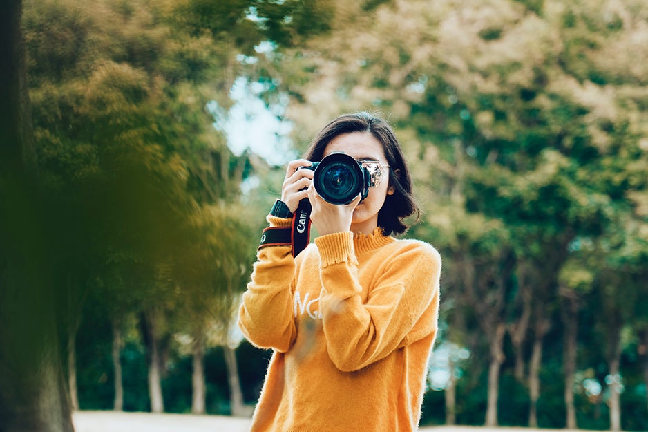 woman taking a photo with a camera