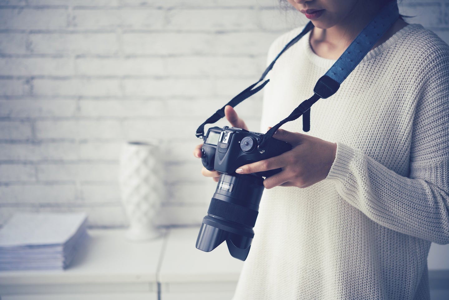 Female photographer checking photos in her camera