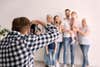 Professional photographer taking photo of family in studio