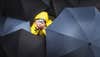 photography umbrellas around photographer in rain coat