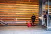 person with red luggage waiting at subway station