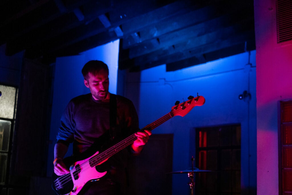 guitarist in colorful dark room
