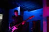 guitarist in colorful dark room