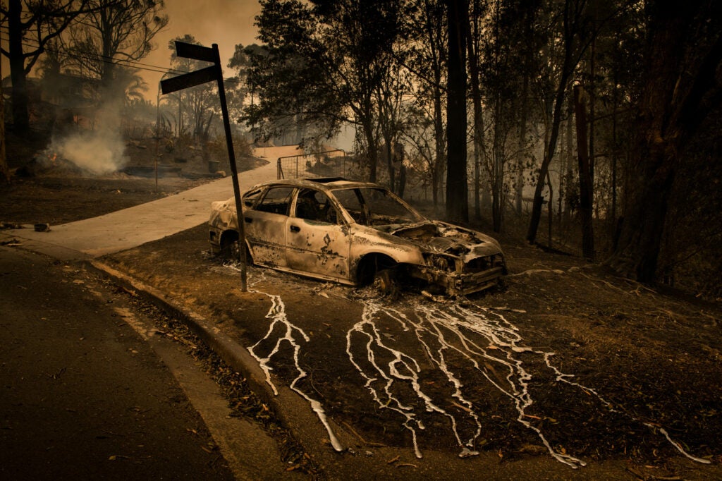 A destroyed car on a street corner in Conjola Park