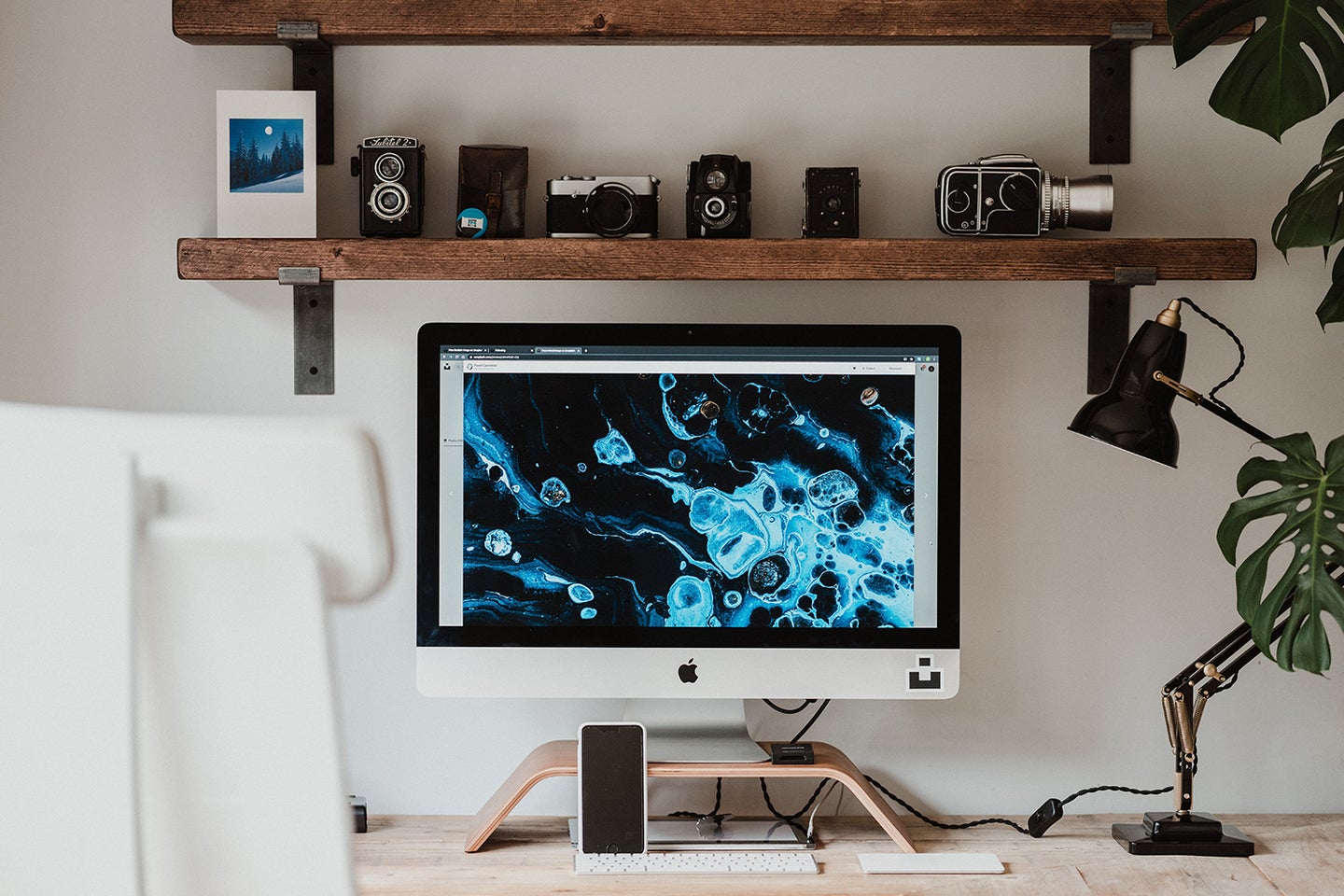 An iMac on a computer desk.