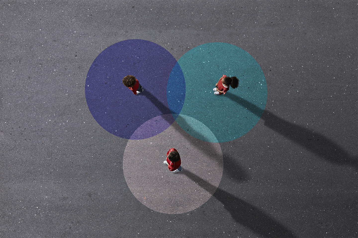 people standing on three intersecting colored circles