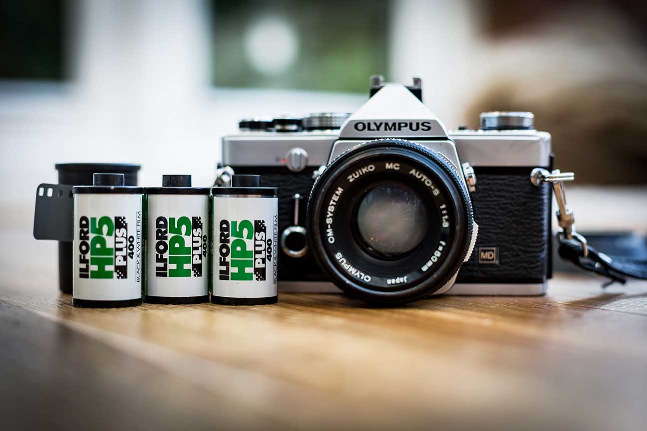 Ilford film next to an Olympus camera