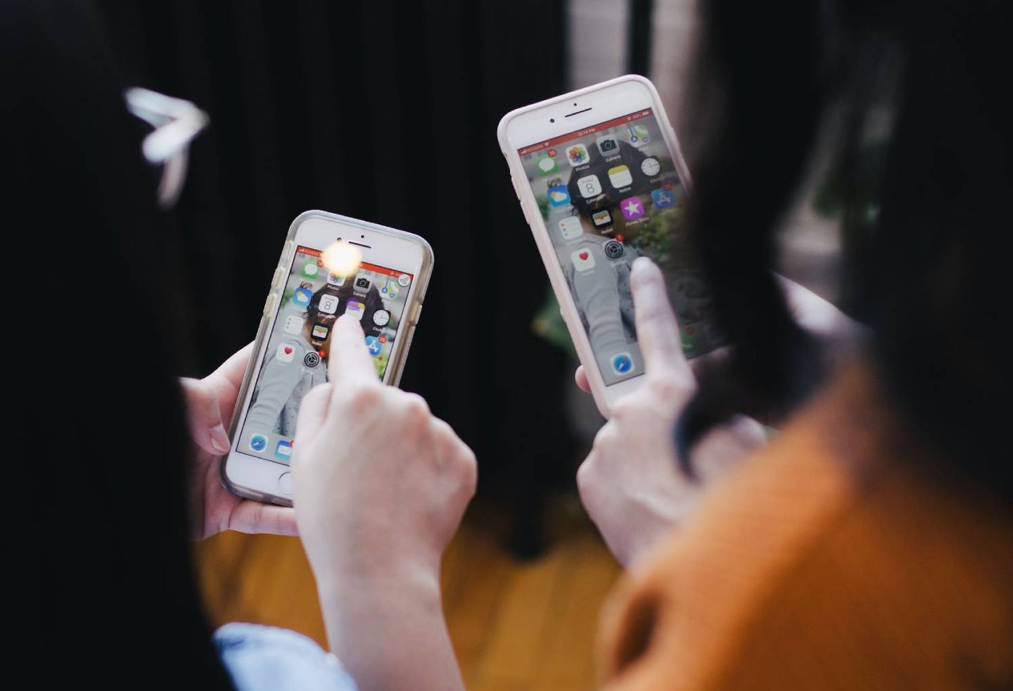 Two people on their phones