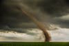 A tornado spins up red top soil in Dix, Nebraska. June 22, 2013.