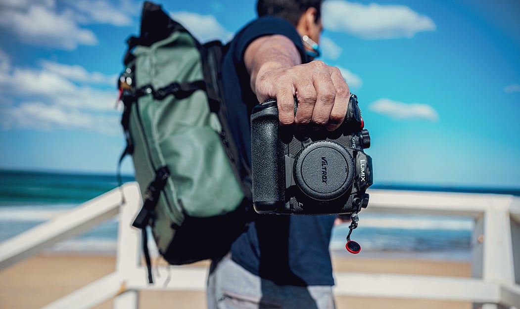 person holding a camera with a backup