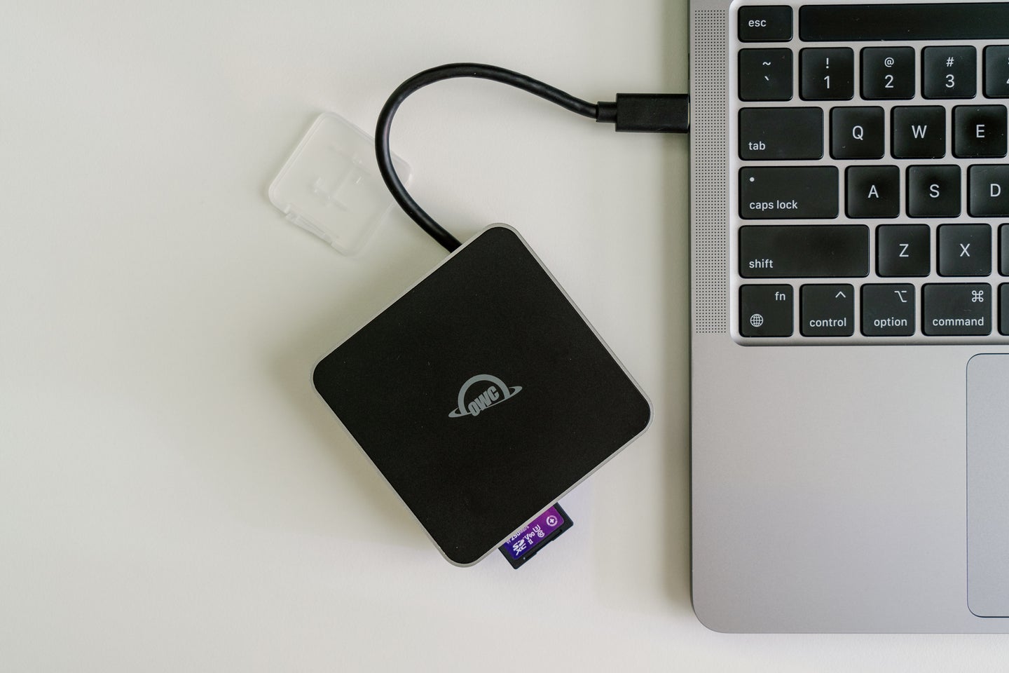 An OWC memory card reader connected to a laptop