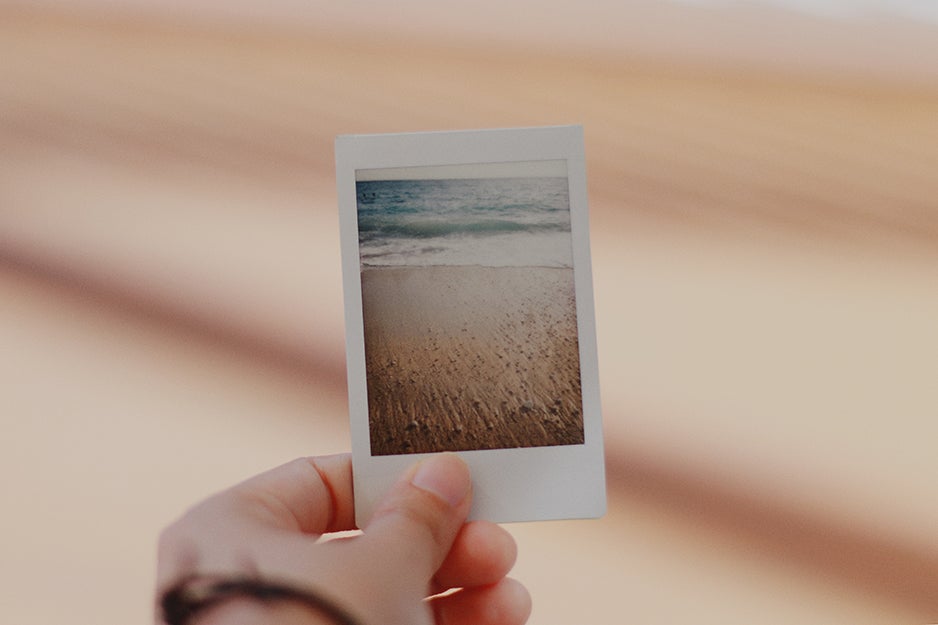 person holding an instant camera print