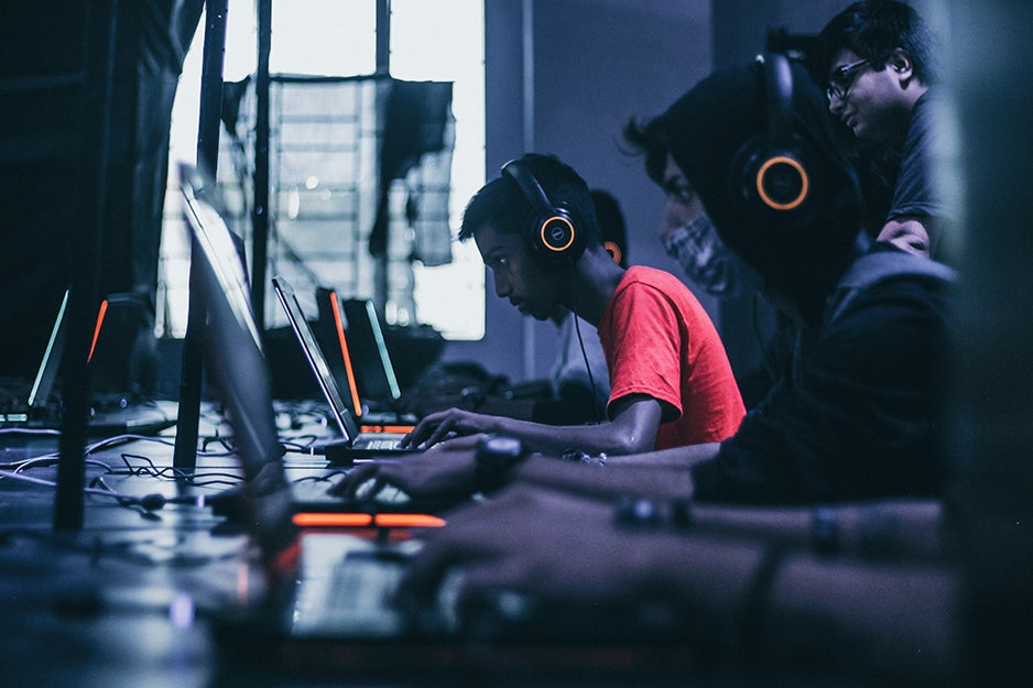 gamers playing on laptops