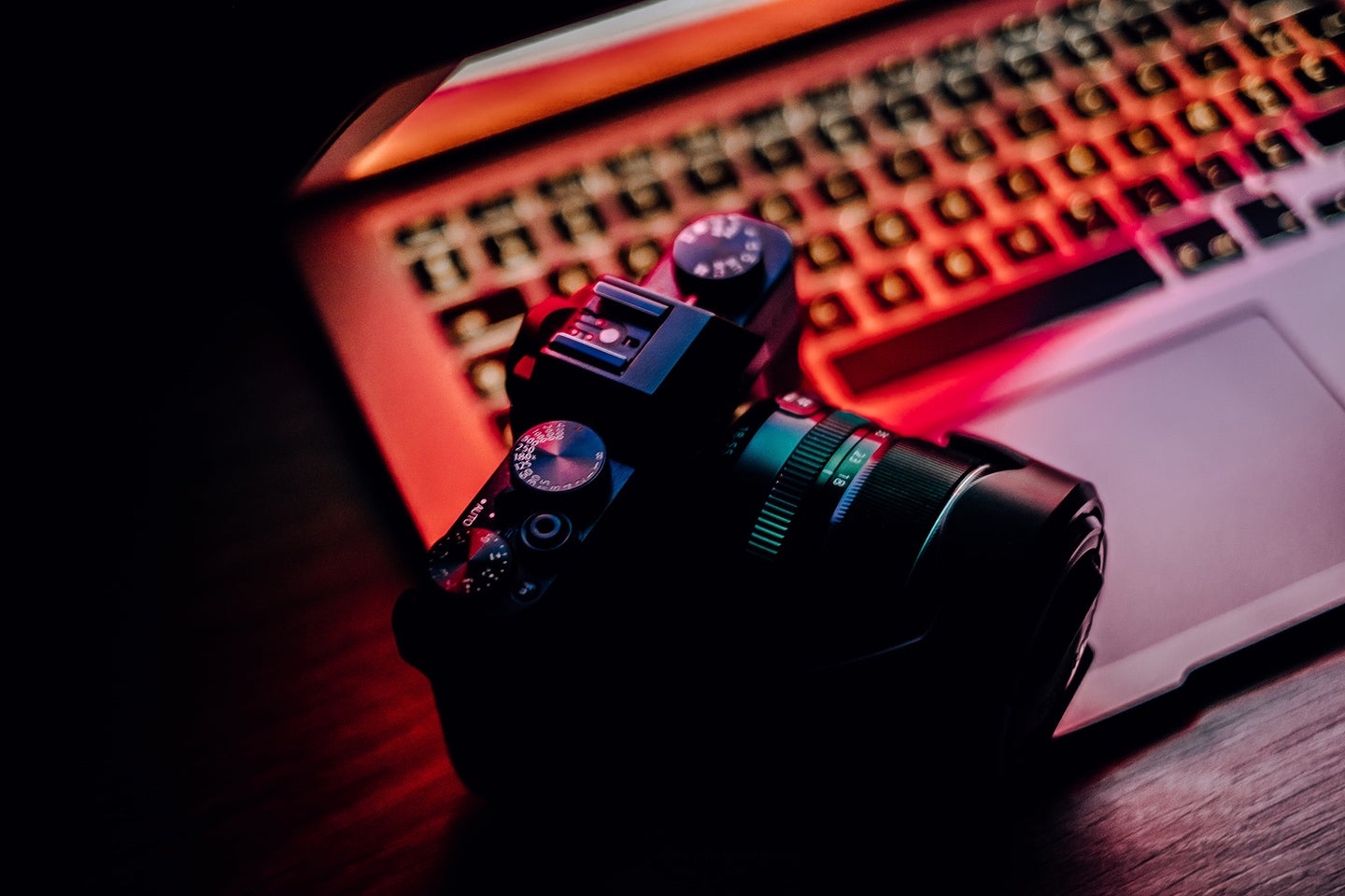 The best mirrorless camera on an apple laptop with red light coming off the screen