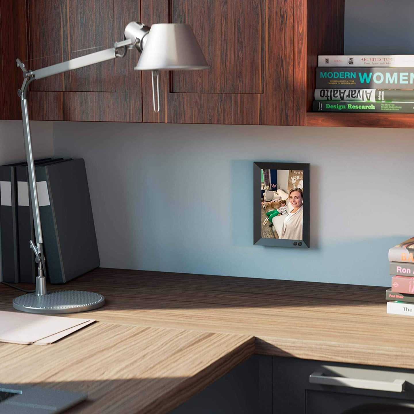 the best digital picture frame, lamp, and books on a desk