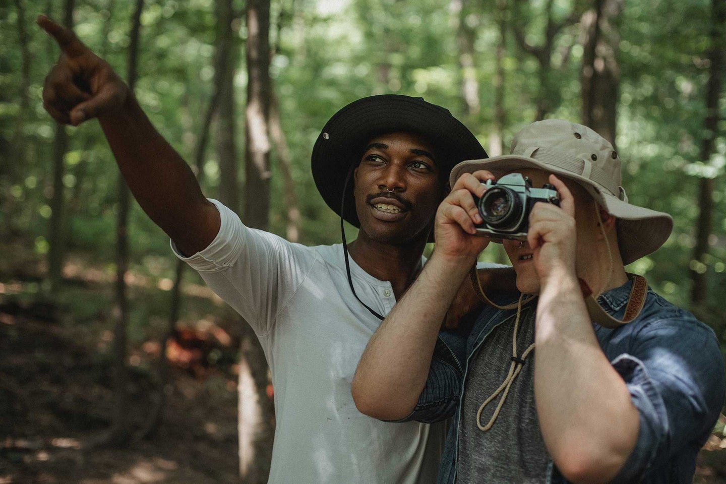 Two men in the woods taking pictures