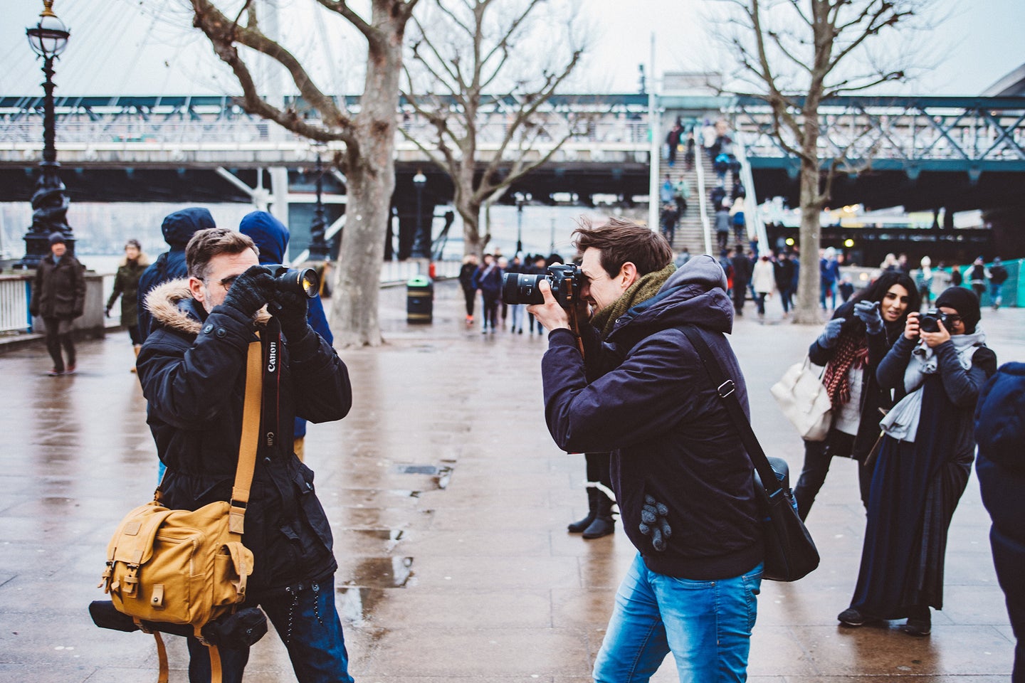 people with cameras and the best camera backpack outside taking photos