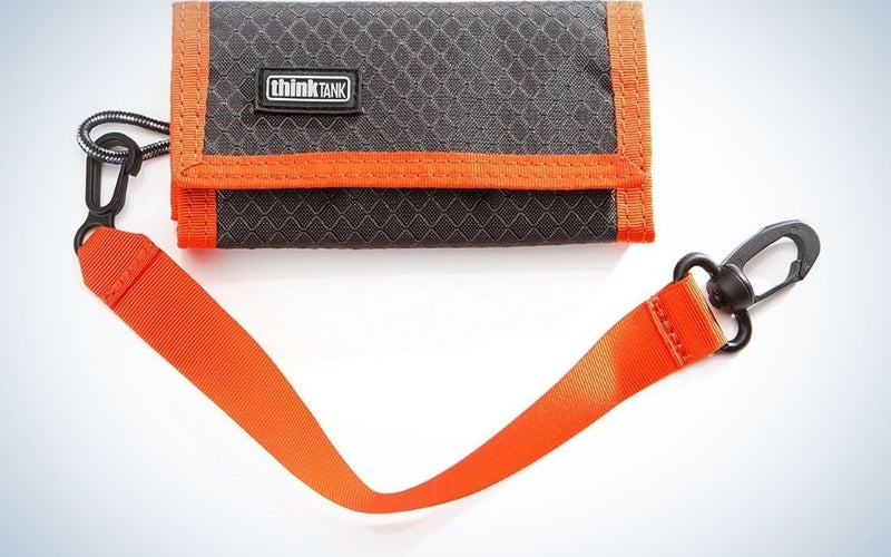 Small Think Tank black pocket with orange lanyard.