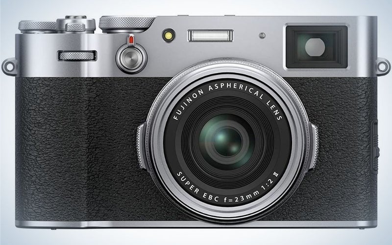A Fujifilm camera with a black body and a silver head from the front.