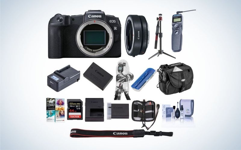 A black Canon camera mirrorless with all package of his set in one photo.
