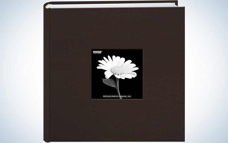 brown photo album with a black and white flower image in the center