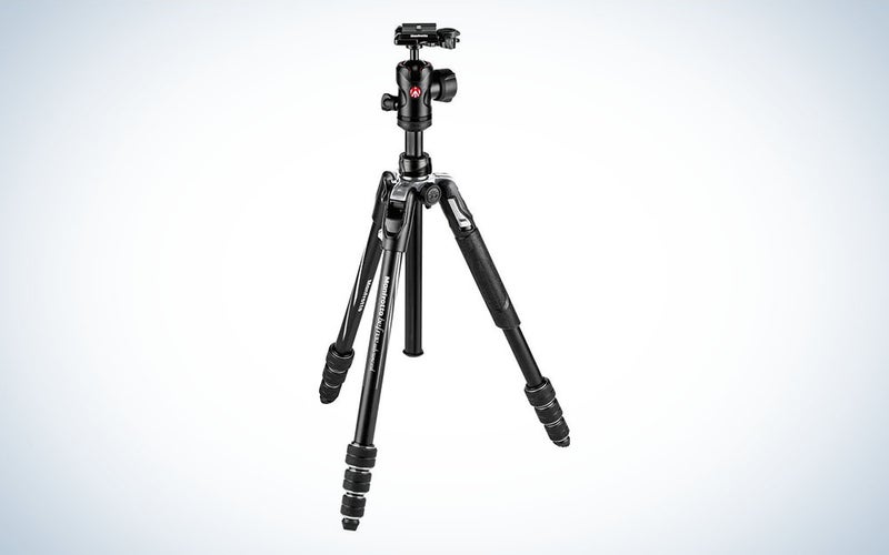 A black compact travel tripod for cameras.