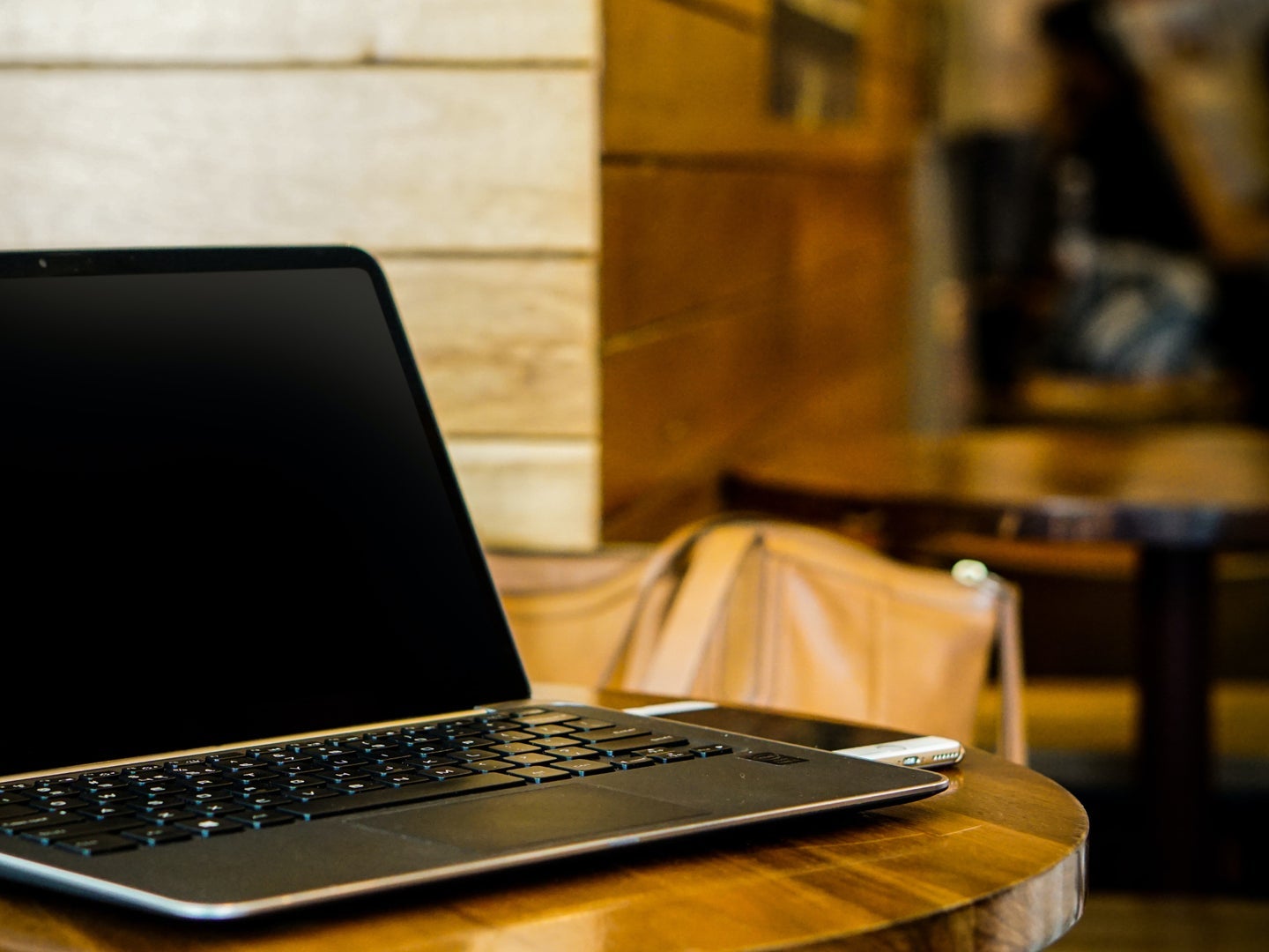 An unattended laptop at a coffee shop.
