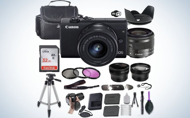 A professional camera with black color and with black lens in front of it, with portable tripod, memory card, lens, camera bag etc.