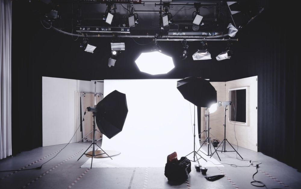 A studio with lamps and strong lights into the room.